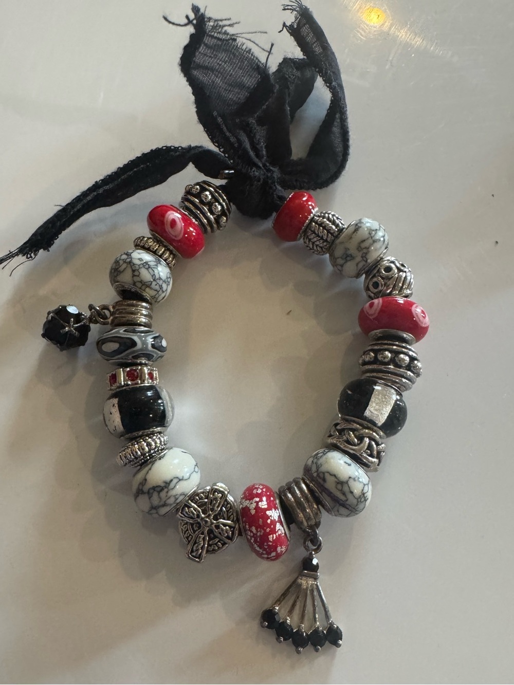 Black, red and white with silver lot of glass and decorative beads.
